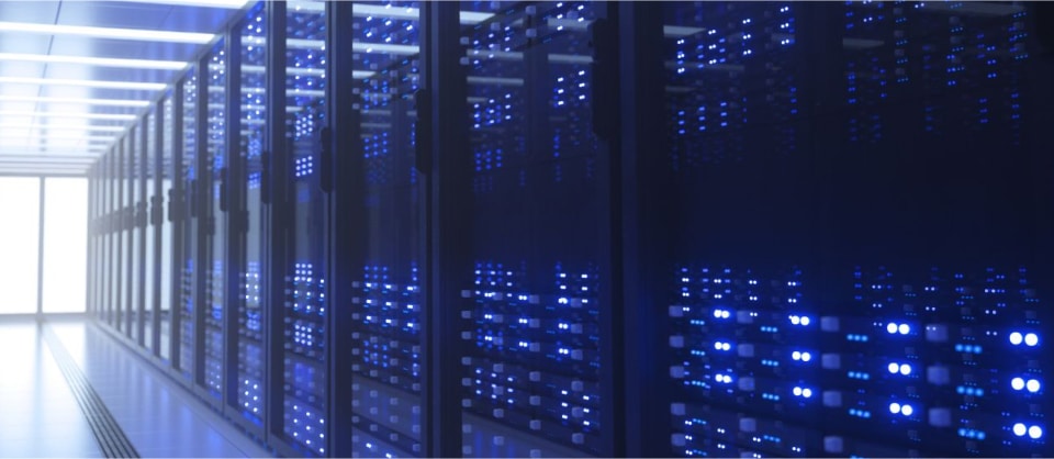 Rows of illuminated server racks in a data center